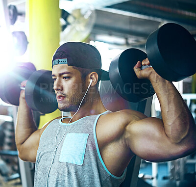 Buy stock photo Dumbbells, earphones and shoulder press with man in gym for strength training or workout routine. Flare, music and weightlifting with bodybuilder in health club for challenge, exercise or fitness