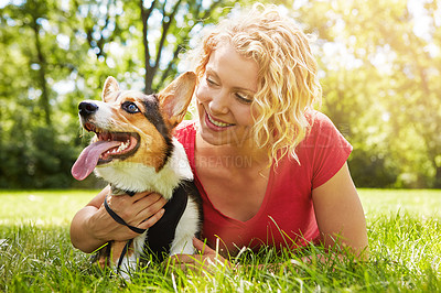 Buy stock photo Happy woman, relax and hug in park with dog appreciation, companion or thought for bonding together. Bokeh, person and embrace in field with Corgi puppy, reflection or gratitude for loyal friendship.