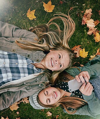 Buy stock photo Phone, reading and scroll with friends in park for social media comment, post status update and text message. Communication app, online platform and bonding with above of girl outdoor as teenager