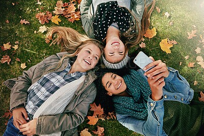 Buy stock photo Friends, selfie and teens on grass, fall and group with memory for season, photography and together. Outdoor, autumn and girls with smile on break, above or profile picture on social media in nature