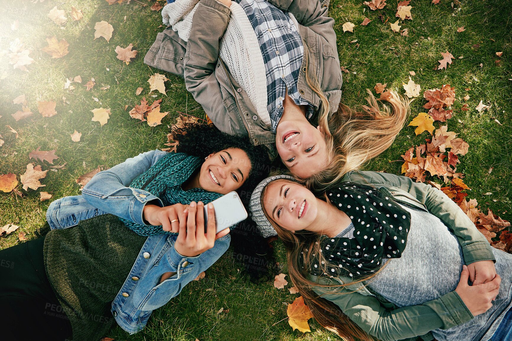Buy stock photo Group, selfie and teens on grass, fall and friends with memory for season, photography and together. Outdoor, autumn and girls with smile on break, above and profile picture on social media or flare