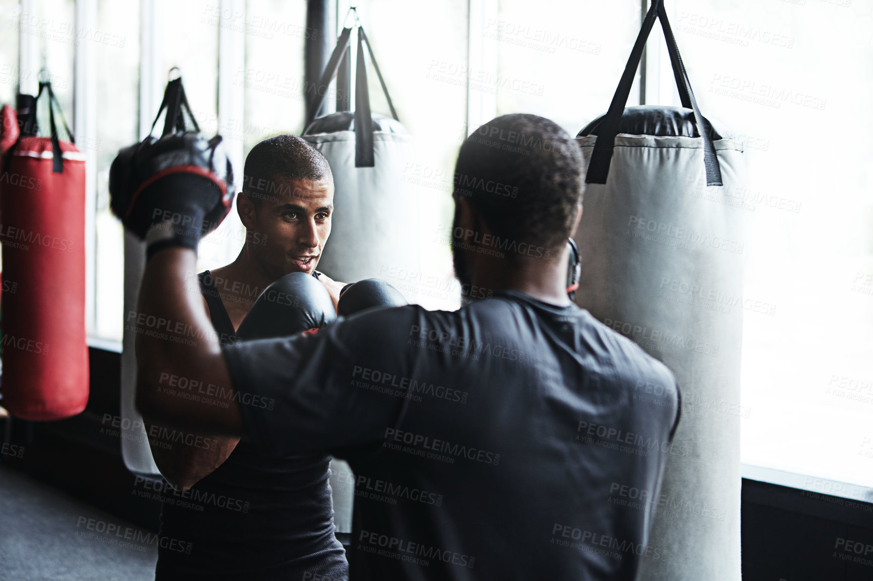 Buy stock photo Man, boxer and fitness with personal trainer at gym for training, punching technique and combat. Person, boxing and coach with mitts for self defense practice, fighting skills and sparring workout