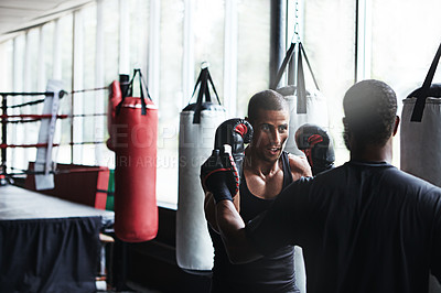 Buy stock photo People, boxing and fitness with personal trainer at gym for training, punching technique and combat. Male boxer, coach and sports mitts for self defense practice, fighting skills and sparring workout