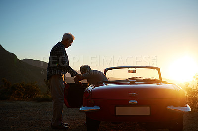 Buy stock photo Senior, couple and help wife at car for road trip break, travel adventure and assistance for sunset. Sunlight, old people or support at convertible for sightseeing, retirement getaway or mockup space