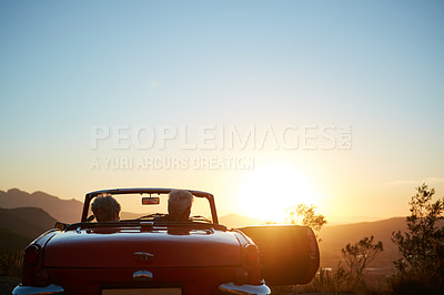 Buy stock photo Sunset, back and senior couple in car for road trip, adventure and holiday together on mountain. Travel, space and elderly man and woman in convertible for bonding, marriage or love on vacation