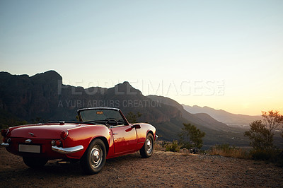 Buy stock photo Sunset, mountain and convertible car in nature for road trip, vacation or getaway in evening. Outdoor, travel and vehicle for driving to holiday destination with scenic adventure i countryside.