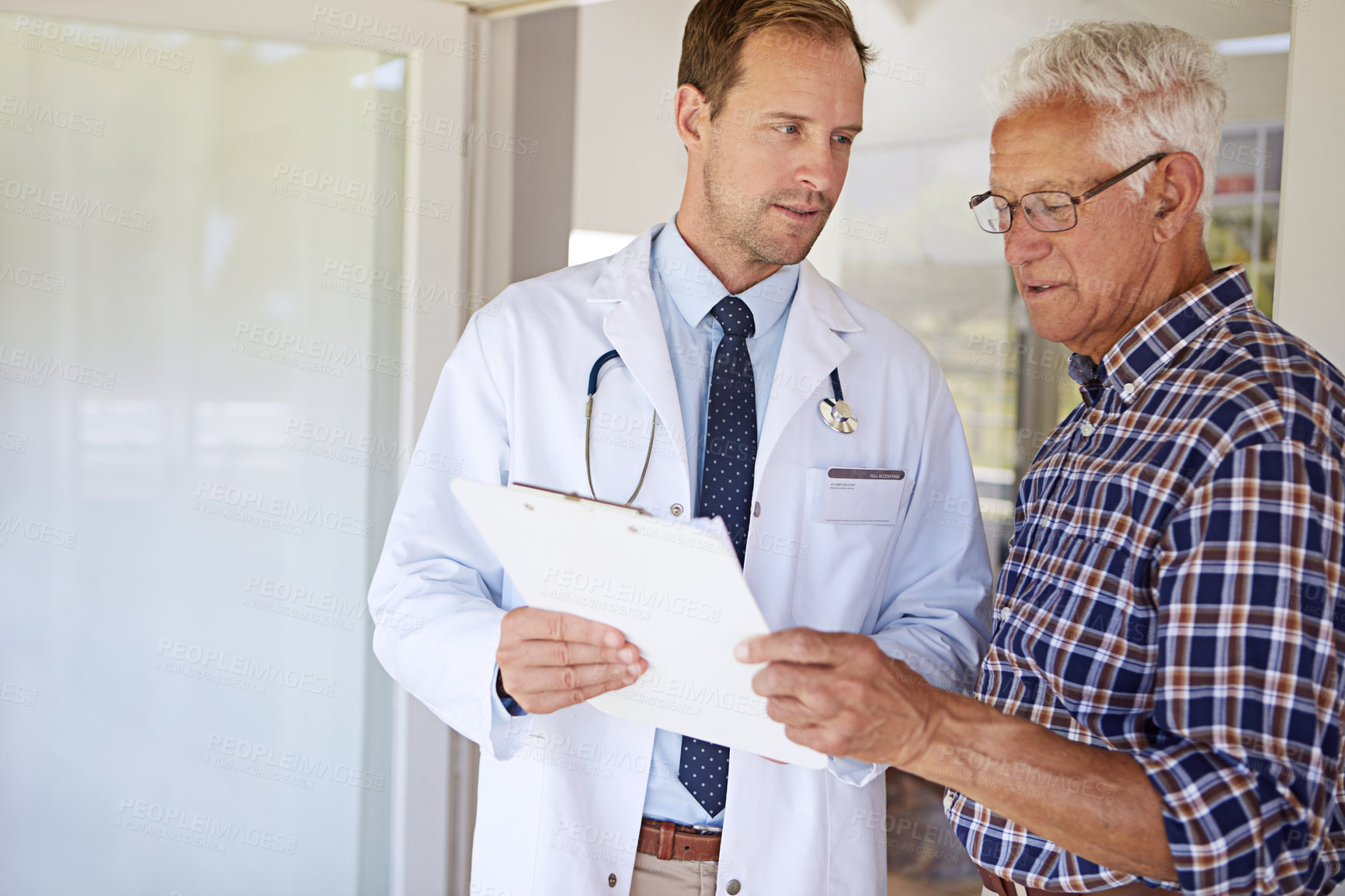 Buy stock photo Clipboard, checkup and doctor with elderly man in clinic for discussion on medical diagnosis. Checklist, consultation and healthcare worker with senior male patient for treatment planning in hospital