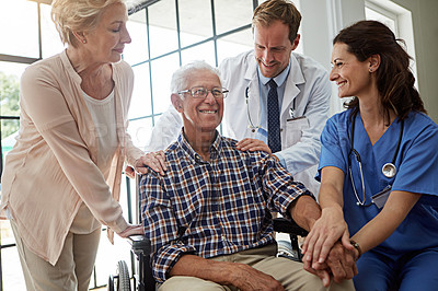 Buy stock photo Happy, doctor and nurse with senior man in nursing clinic for healthcare discussion together. Couple, checkup and elderly male patient in wheelchair with medical employees in retirement facility.