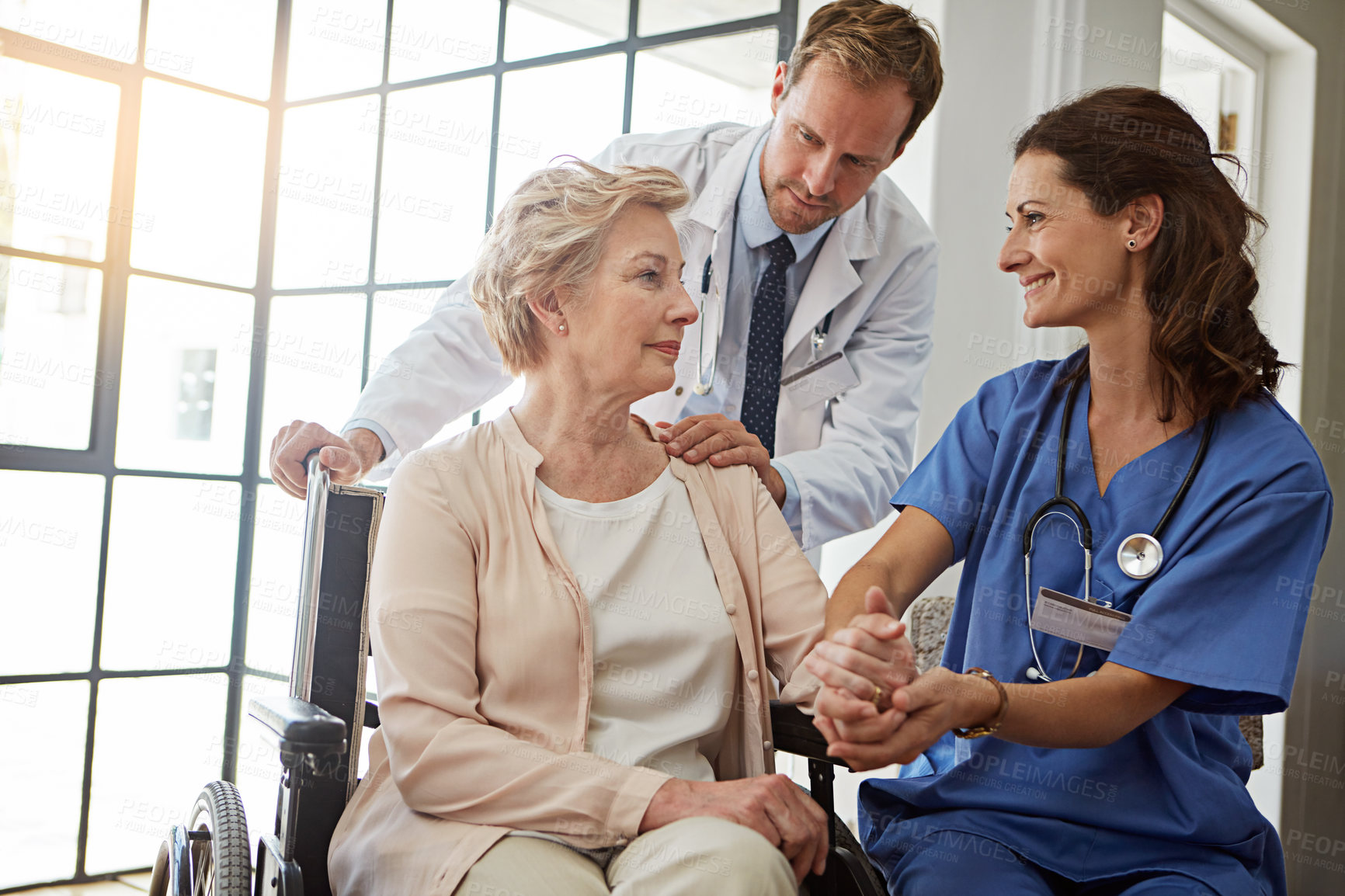 Buy stock photo Doctor, nurse and old woman in wheelchair for healthcare, medical consulting or recovery. Conversation, holding hands and rehabilitation of senior person with disability in hospital for healing