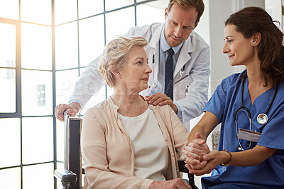 Buy stock photo Doctor, nurse and senior patient in wheelchair, holding hands for healing or healthcare consulting. Conversation, medical and recovery of old woman with disability in hospital for rehabilitation