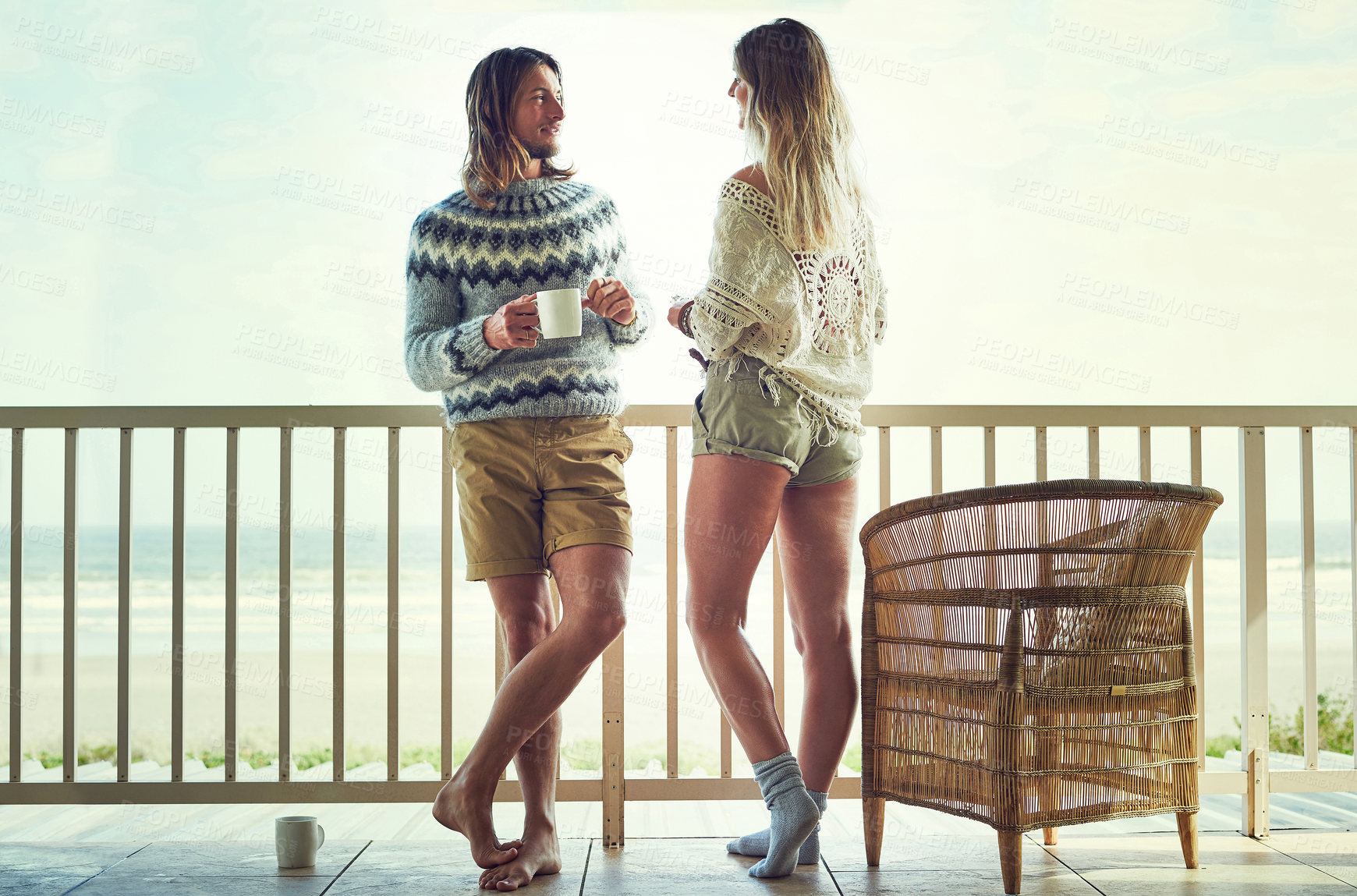Buy stock photo Love, getaway or couple on balcony with coffee, healthy relationship or bonding on seaside trip. Connection, man or woman on patio with warm drink, commitment or morning together on romantic holiday.
