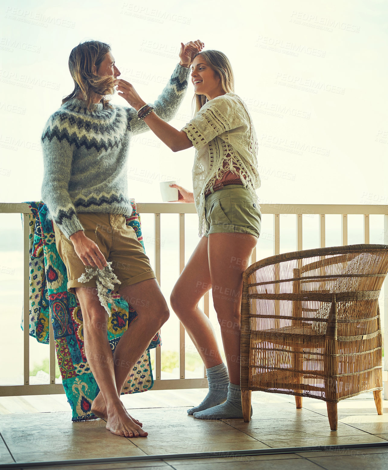 Buy stock photo Smile, couple and relax on balcony outdoor with love, affection and bonding on holiday trip. Happy, people and coffee on patio to start day, partner admiration and care for getaway vacation at resort