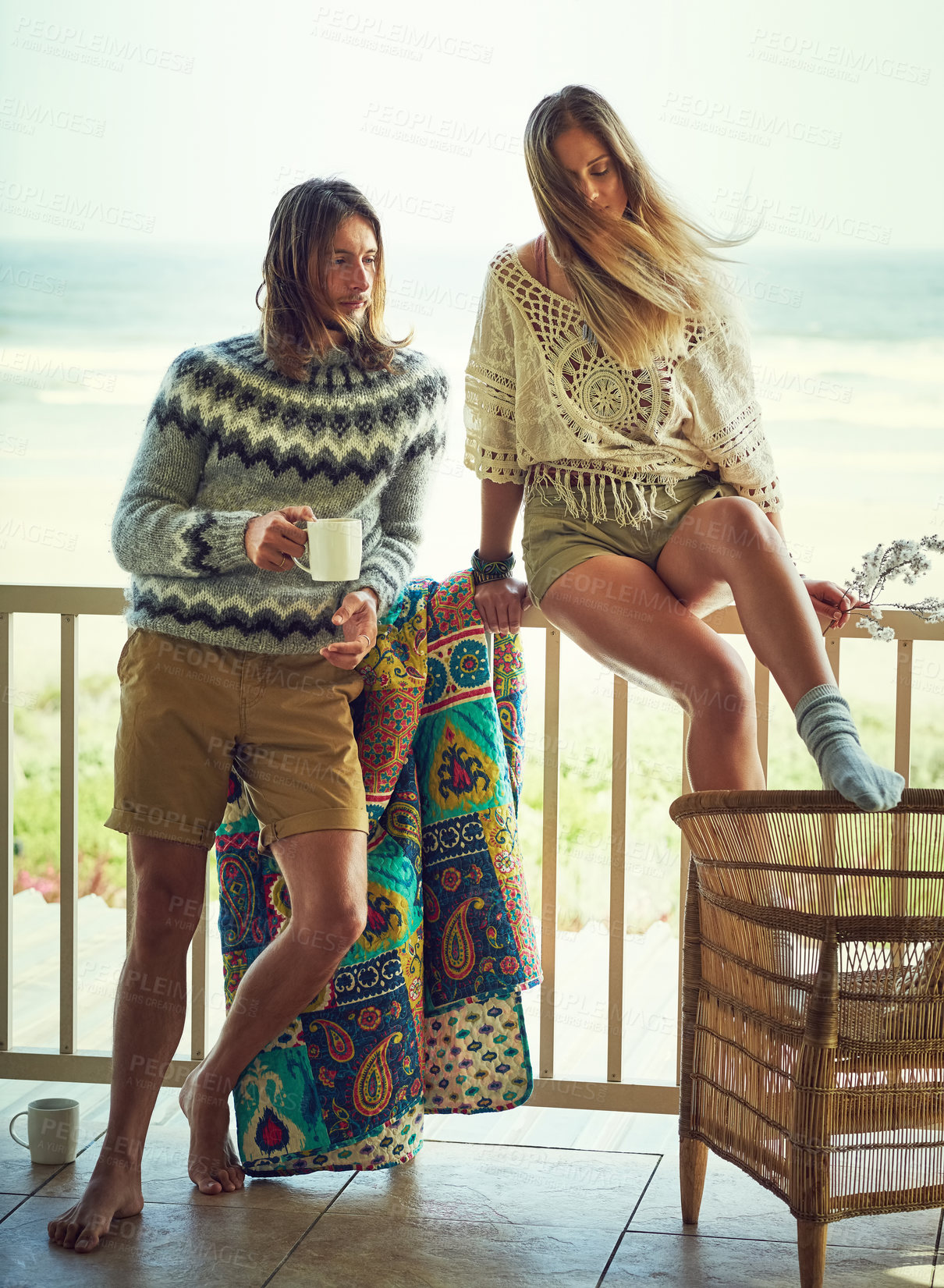 Buy stock photo Summer, trip or couple on balcony with mug, healthy relationship or bonding on beach vacation. Smile, man or woman at seaside with coffee cup, connection or morning together on romantic holiday.