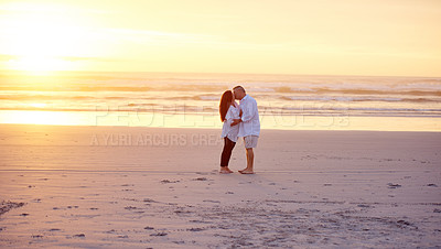 Buy stock photo Mature couple, love or kiss on beach with sunset, connection or summer holiday for bonding together. Married people, affection or outdoor by ocean with vacation, loyalty or care for romantic getaway.