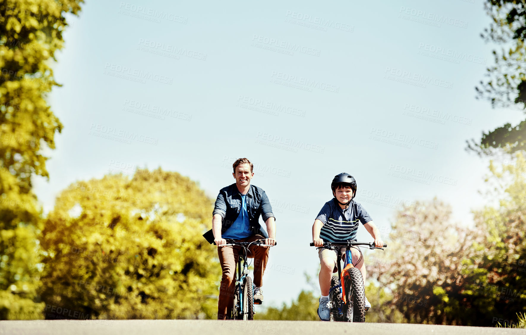 Buy stock photo Dad, boy and happy on bicycle in road for ride, bonding and love with space in neighborhood. People, father and child with cycling, bike or smile with helmet, portrait and connection in Portugal