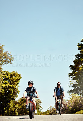 Buy stock photo Happy dad, child and riding with bicycle for bonding, fun childhood or physical activity together. Father, son or cycling with kid on road or space for travel, learning or health in neighborhood