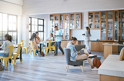 Buy stock photo Education, students and learning in library at university in relax, funky and creative study room. Diversity, college and learners in social space, reading, homework and research with book and pupils