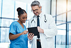 Teamwork, tablet and healthcare with a doctor and nurse working together as a team in the hospital. Collaboration, internet and medical with a man and woman surgeon at work on an online diagnosis