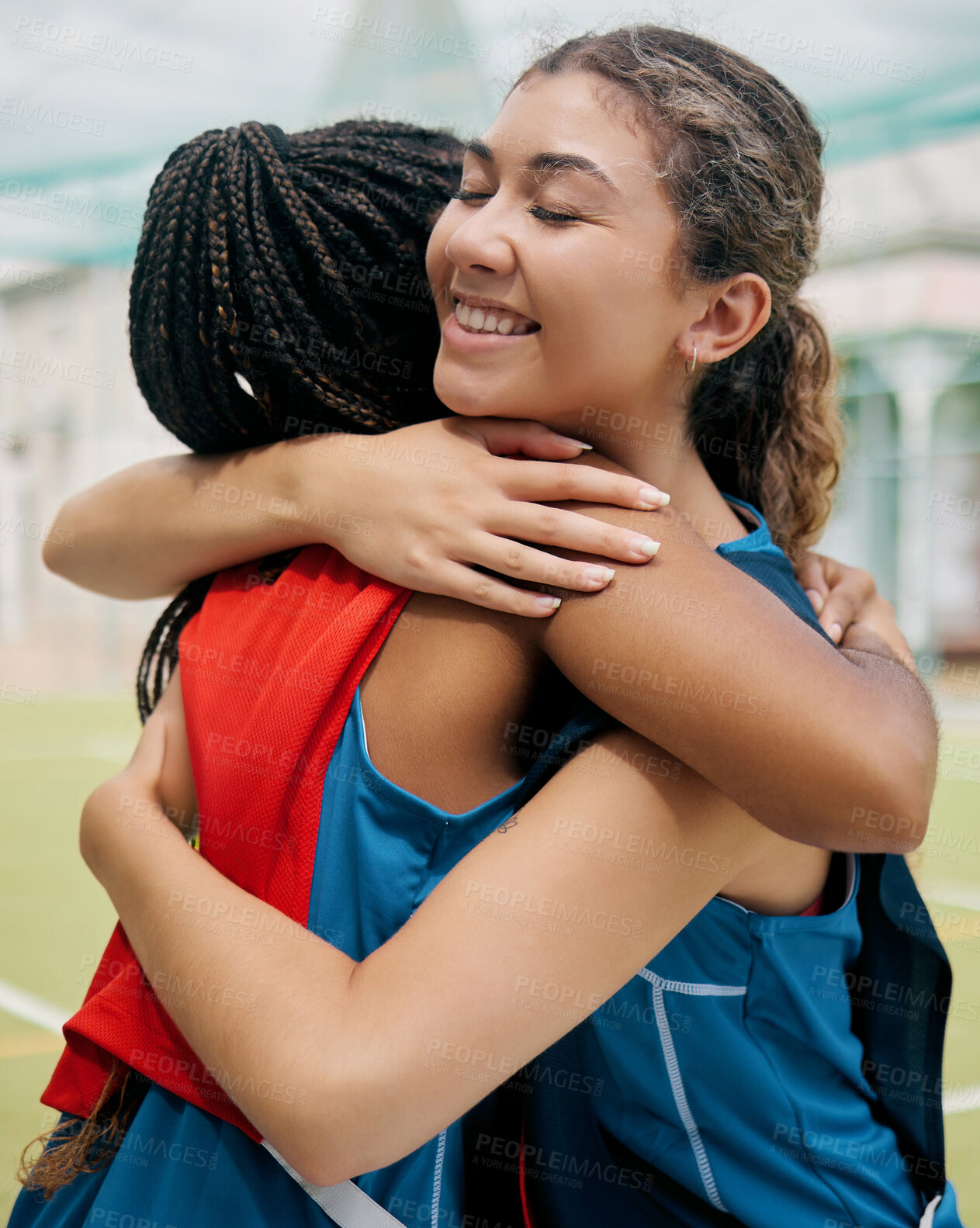 Buy stock photo Sport, hug and student girl game match showing support, trust and teamwork on a outdoor field. Student soccer or netball player with a happy smile show diversity and congratulations together