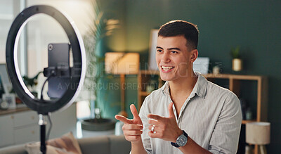 Buy stock photo Man, light and phone for live stream in house, smile and fingers for yes announcement. Online, Male influencer and website in home with mobile, creative review for audience with media technology