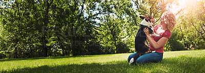 Buy stock photo Cuddle, flare or playful with dog and woman outdoor together for animal care, bonding or loyalty. Banner, grass field or space and pet owner playing with corgi puppy on lawn in park for wellness