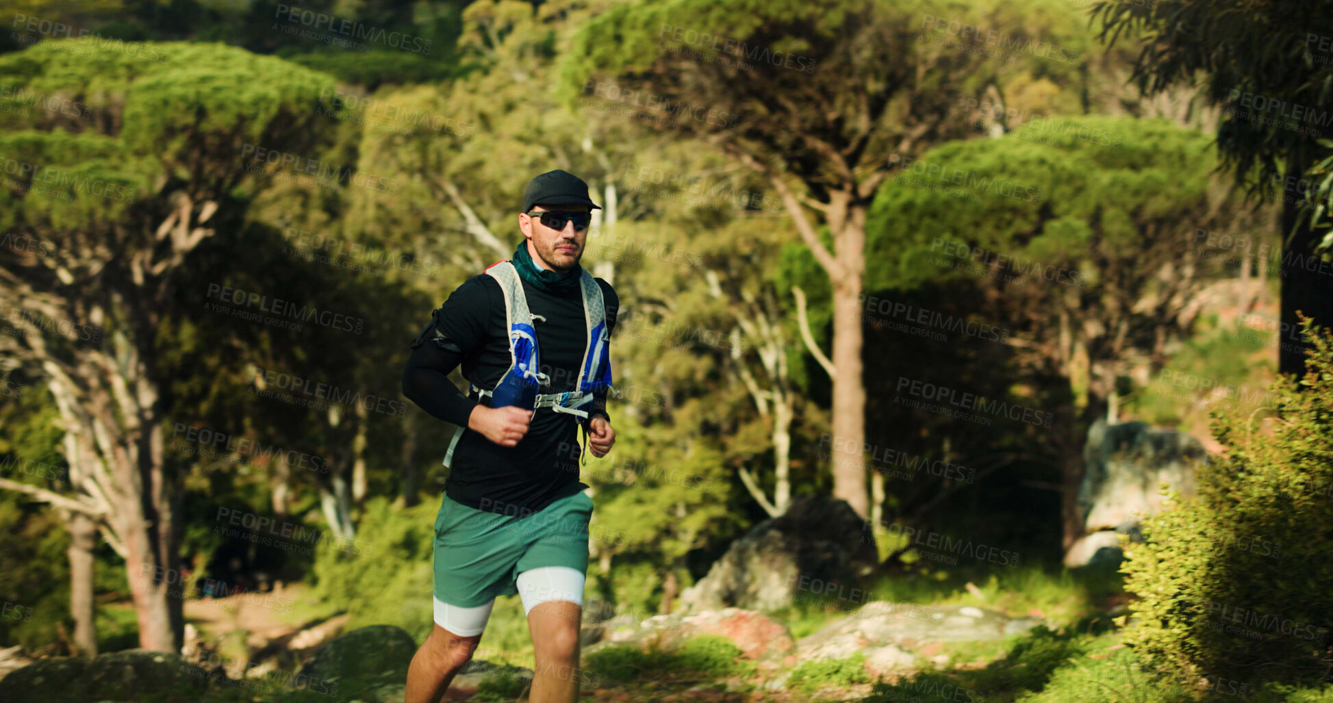 Buy stock photo Running, fitness and man in forest, nature and endurance with wellness, trail and cardio workout. Outdoor, healthy person and runner with exercise, energy and challenge with training and practice