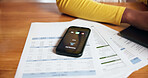 Documents, phone screen and ringing with person at desk in home office for accounting or finance. Communication, paperwork and remote work with mobile on table in apartment for call or contact