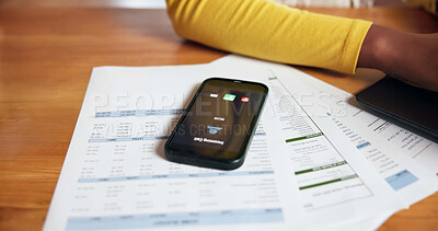 Buy stock photo Documents, phone screen and ringing with person at desk in home office for accounting or finance. Communication, paperwork and remote work with mobile on table in apartment for call or contact