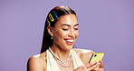 Woman, phone and texting with fashion, studio and happy with mockup space on purple background. Gen z person, smartphone and mobile app with online dating, style and scroll web chat on social media