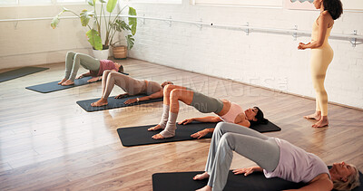 Buy stock photo Woman, glute bridge and exercise with group, coach and balance with muscle development at gym. People, training and guide for routine in class, wellness or workout for strong legs at fitness club