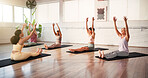 Yoga class, instructor and women with warm up in studio for wellness, morning exercise and flexibility. Pilates, personal trainer and group of people in health club for wellbeing, zen and workout