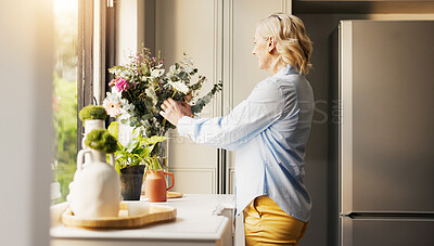Buy stock photo Arrangement, flowers or mature woman in home with smile, horticulture or aesthetic for green decoration. Sorting, hobby or senior person in kitchen with plant, vase or floral display in house care