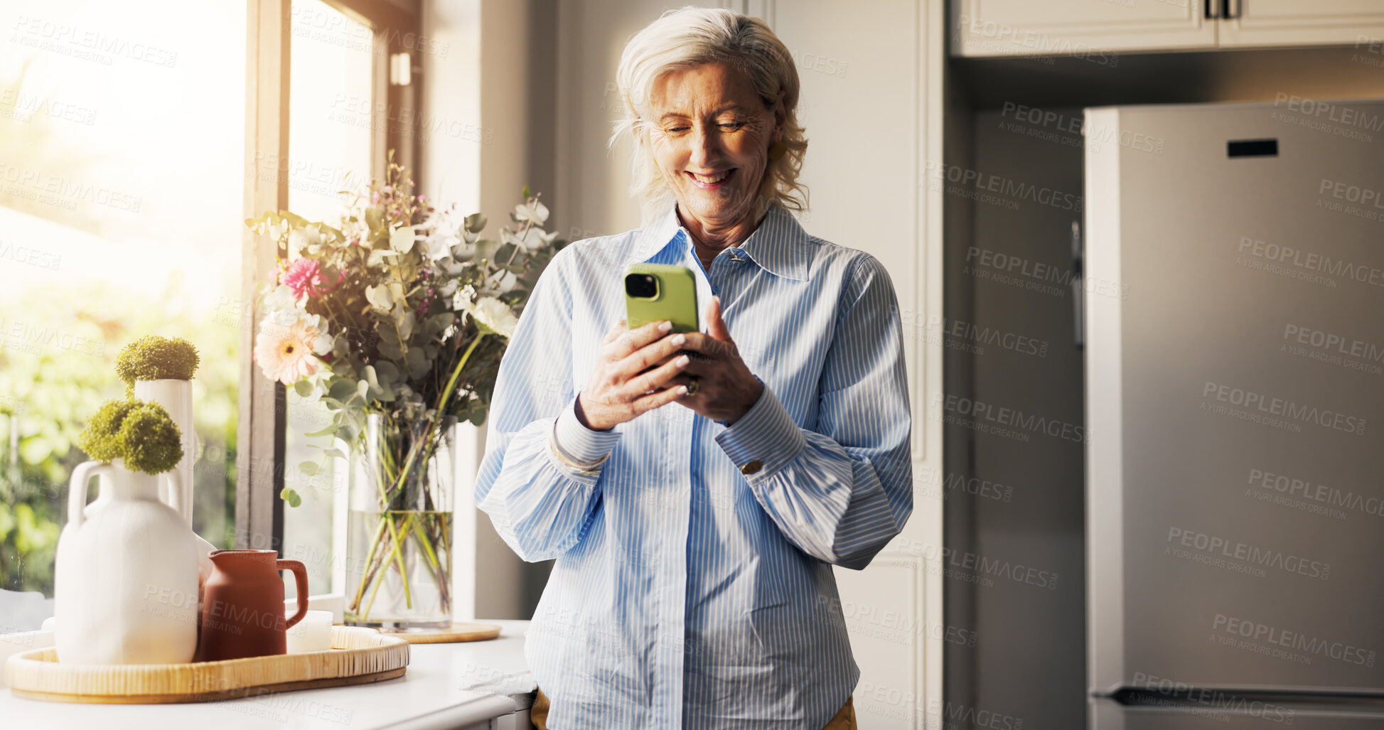Buy stock photo Home, smartphone and senior woman with smile, retirement and connection with social media. Window, digital app and mature person with tech, internet and lens flare with funny meme and communication