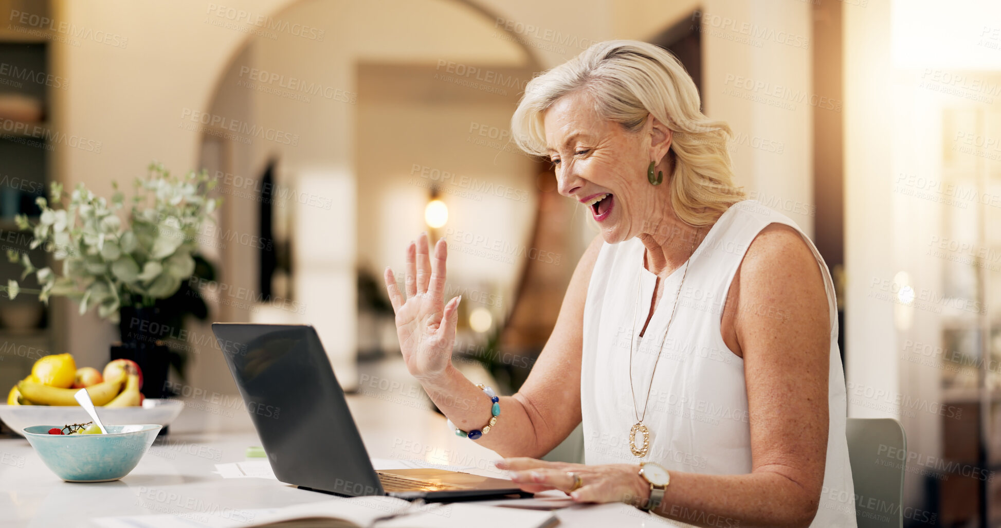 Buy stock photo Woman, laptop and remote work from home, video call or wave for investment broker in kitchen. Mature person, financial advisor and agent for virtual meeting, hello or smile with networking at house
