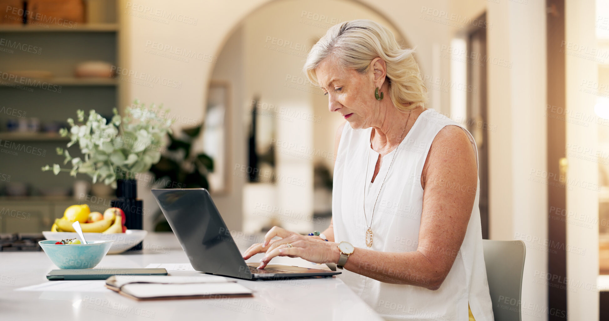 Buy stock photo Woman, laptop and remote work from home, typing and editing report with deadline in kitchen. Mature person, freelance writer and computer for project management, flare and story on web at apartment
