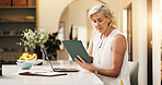 Woman, laptop and reading with tablet for project draft, editing article and creative process in home. Remote work, freelance writer and tech for proofreading with mature editor or story development
