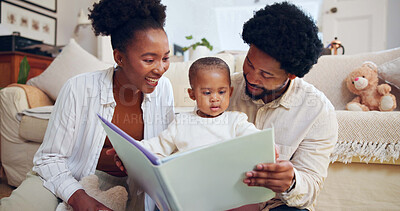 Buy stock photo Happy, black family and dinosaur book with child in home for story, bonding or childhood development. Mom, dad and reading with toddler, kids novel or smile for learning or fantasy together in house