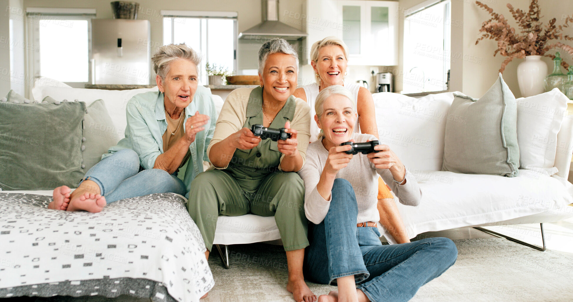 Buy stock photo Mature, happy women or playing with video games on sofa for friendly competition or match in home. Excited, female people or group of gamers with smile for console entertainment on couch in house