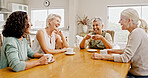 Laughing, friends or senior woman at table for reunion, share funny story or comic experience together. Tea party, retirement or happy people bonding at gathering in home, weekend visit or humor chat