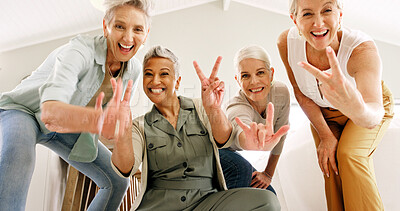 Buy stock photo Excited, hand gesture and portrait of old women in home together for bonding or fun from below. Energy, peace sign and thumbs up emoji with group of happy senior friends in apartment for retirement
