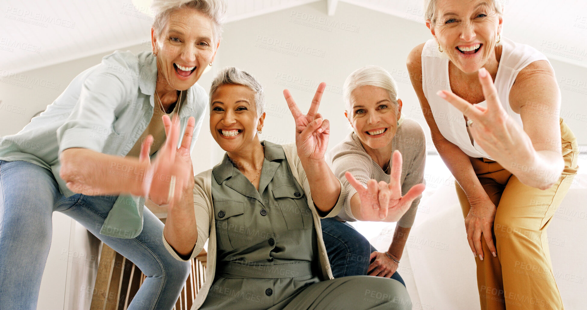 Buy stock photo Excited, hand gesture and portrait of old women in home together for bonding or fun from below. Energy, peace sign and thumbs up emoji with group of happy senior friends in apartment for retirement