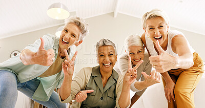 Buy stock photo Energy, hand gesture and portrait of senior women in home together for bonding or fun from below. Excited, peace sign and thumbs up with group of old friends in apartment for emoji or retirement