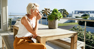 Buy stock photo Home, woman and relax with coffee on balcony for calm morning, sun basking and weekend break. Peaceful, mature person and drinking beverage outdoor at house for fresh air, start day or summer holiday