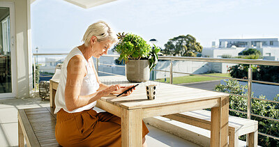 Buy stock photo Balcony, coffee and tablet with woman at apartment for break, scrolling or social media. App, home or relax and mature female person with drink outdoor for fresh air, me time or mobile planning