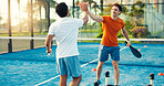 Padel, coach and men on court high five for training, practice and exercise for challenge success. Fitness, personal trainer and people celebrate for game, tennis match and competition outdoor