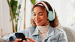 Relax, woman or phone with headphones on sofa for social media video, music album or weekend break. Smile, person and smartphone in home for listening to podcast, sound playlist and streaming service