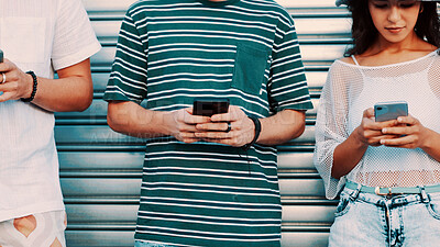 Buy stock photo Hands, phone and typing with friends outdoor together for connection or social media browsing. App, contact and text message with group of people in line for communication, online chat or reading