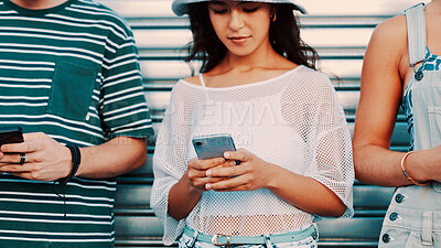 Buy stock photo Garage, phone and texting with woman outdoor for connection or social media browsing. App, contact and typing message with group of friends in line for chatting online, communication or reading