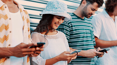 Buy stock photo Phone, smile and typing with friends outdoor together for connection or social media browsing. App, contact and text message with group of happy people in line for chatting online or communication
