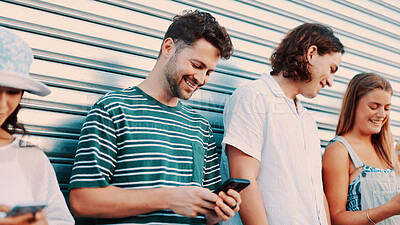 Buy stock photo Break, phone and typing with happy friends outdoor together for connection or social media browsing. App, smile and text message with group of people in line for communication, online chat or reading